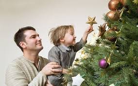 Dad and child decorating tree